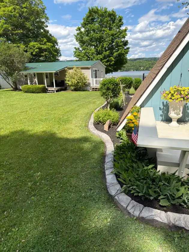 Stamped concrete curbing bordering a front-yard lawn and garden beds