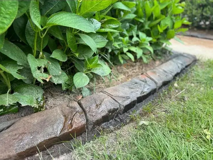 Landscape curbing with stamped pattern around garden